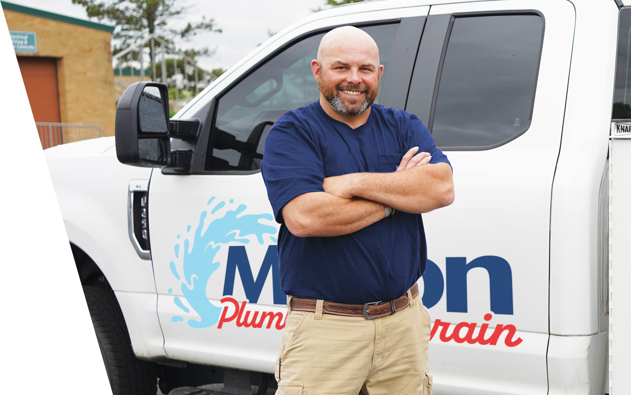 Plumber in front of truck